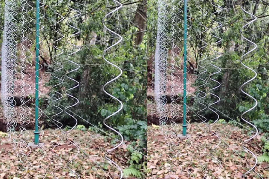 Solar fence with zigzag wire strands installed in a forest area to mitigate human-wildlife conflict in Kerala